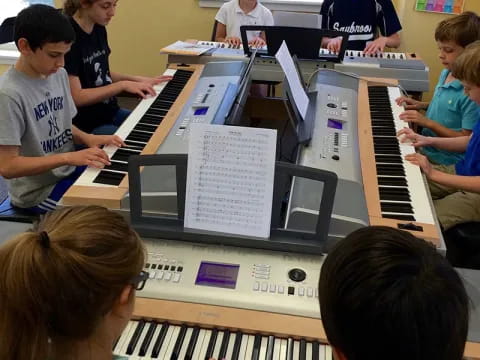 a group of kids playing piano