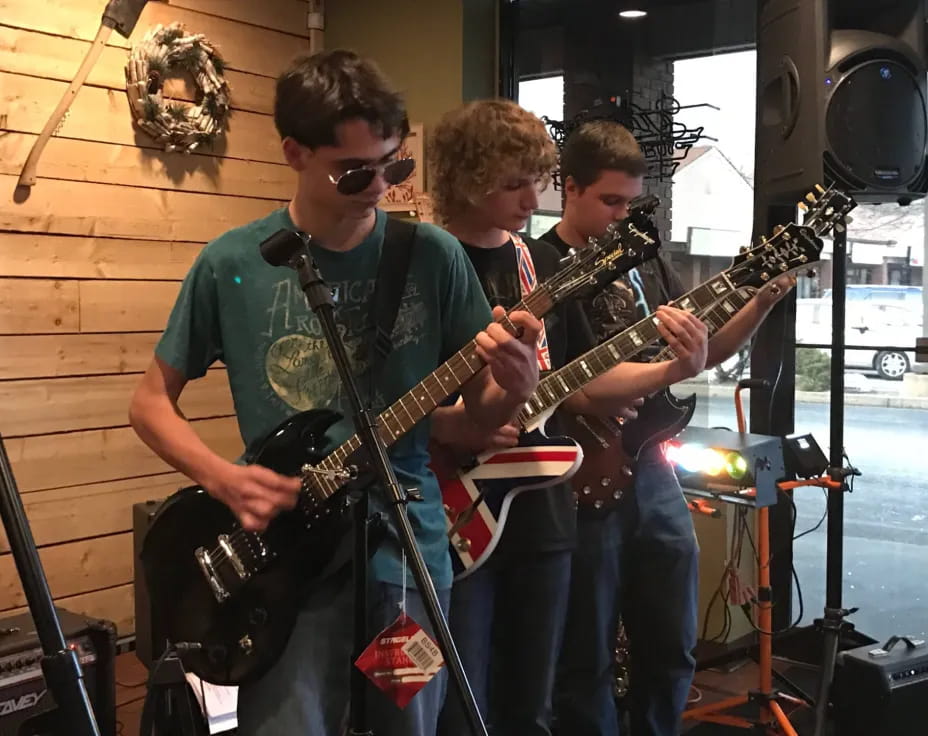 a group of men playing guitars