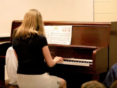 a woman playing a piano