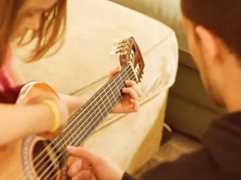a woman playing a guitar