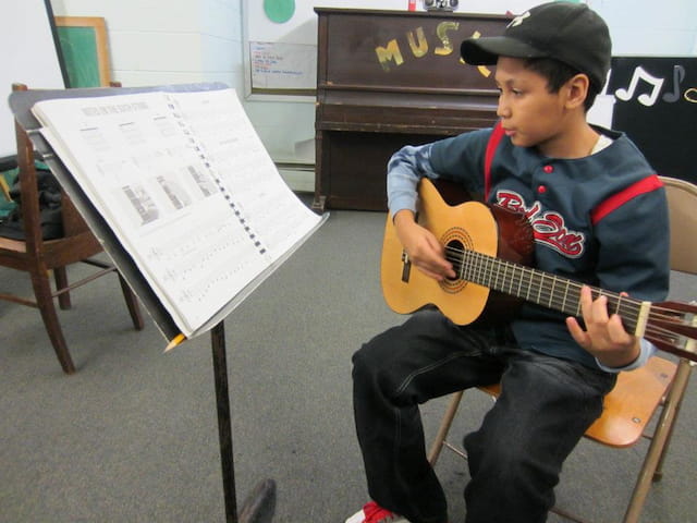 a boy playing a guitar