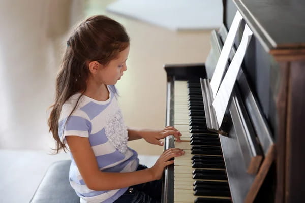 a girl playing a piano