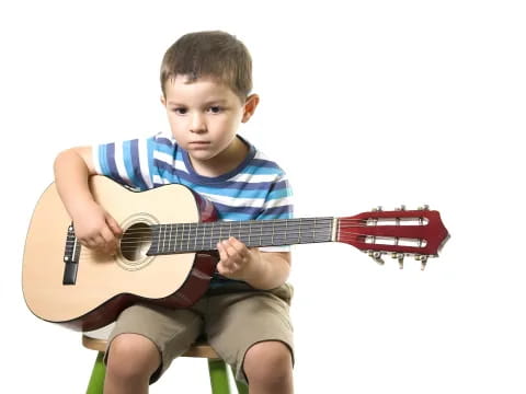 a boy playing a guitar