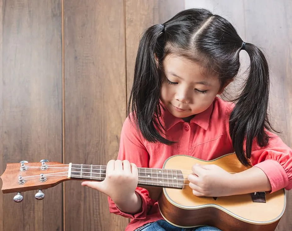 a girl playing a guitar