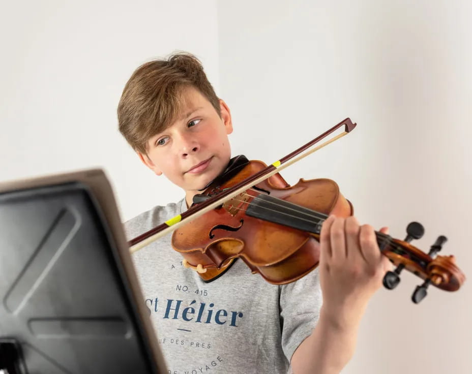 a boy playing a violin