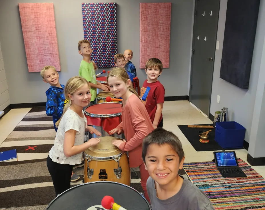 a group of kids playing drums