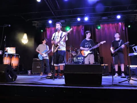 a group of people playing instruments on a stage