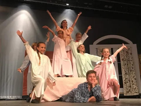 a group of people in white dresses