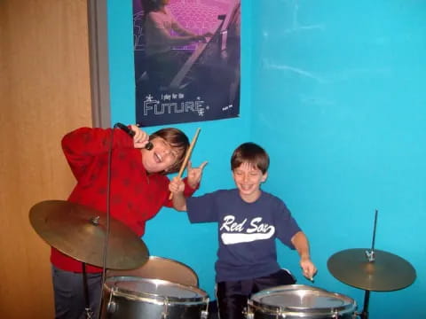 a man and a boy playing drums