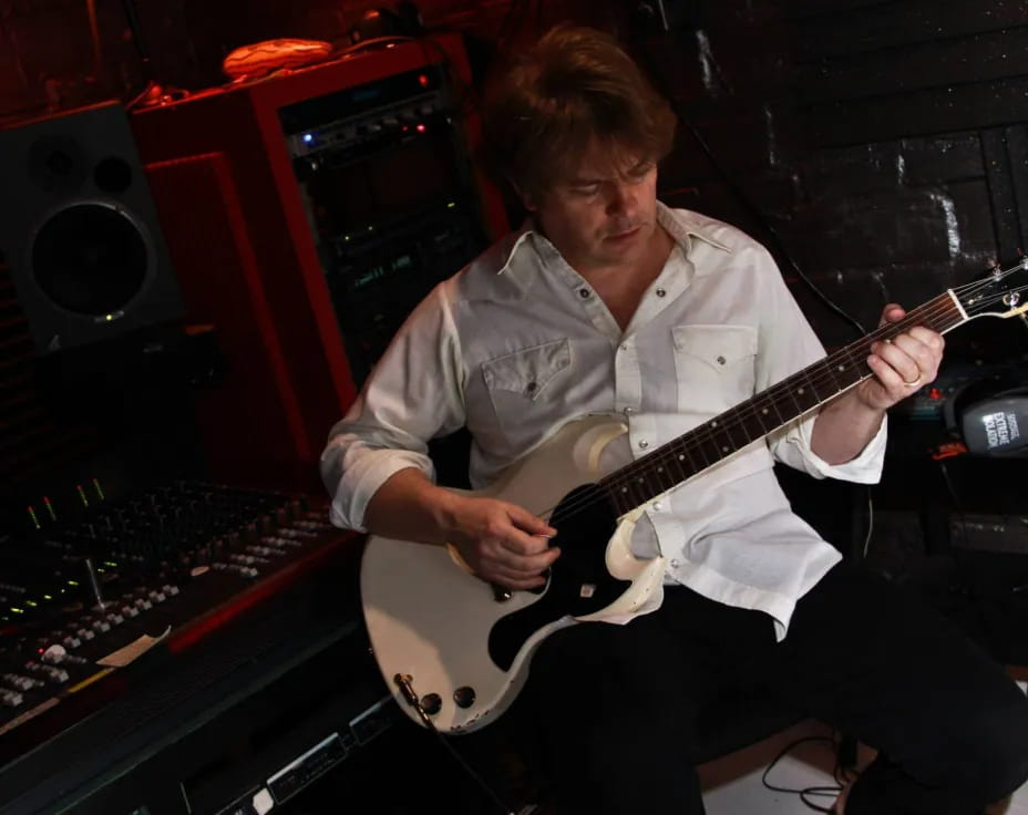 a man playing a guitar