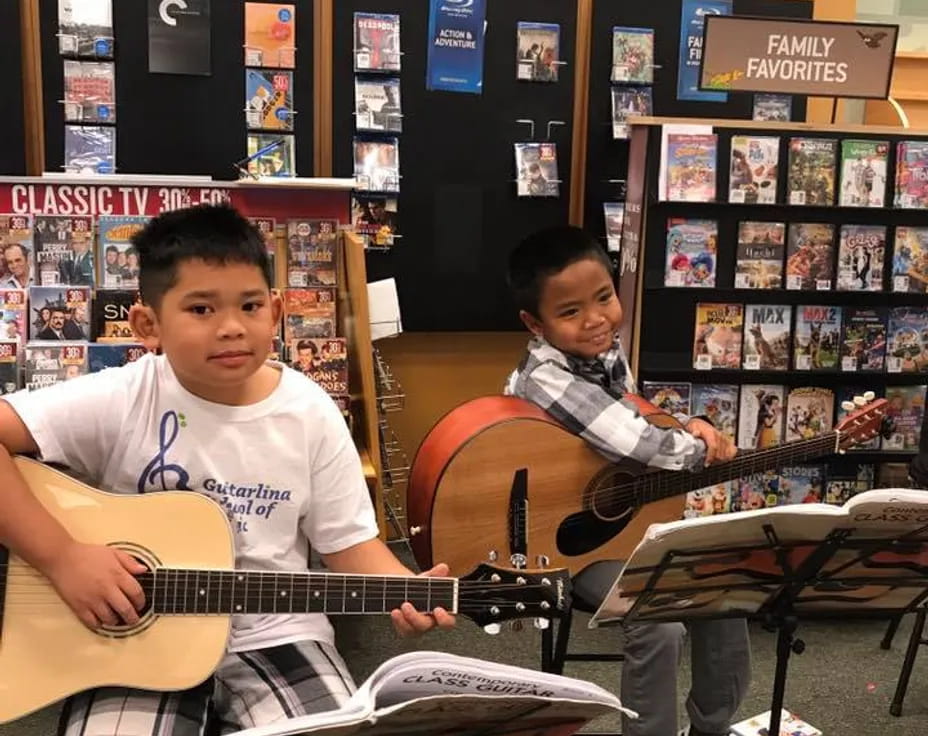 a group of boys playing guitars