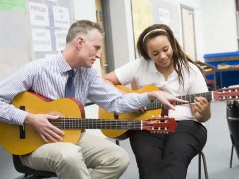 a man and a woman playing guitars