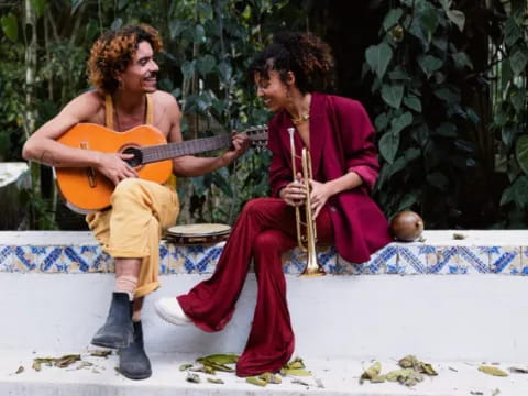 a man and woman playing guitar