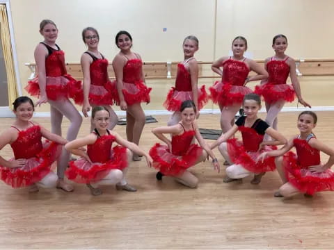 a group of women in red dresses