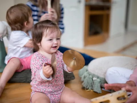 a baby girl holding a cookie