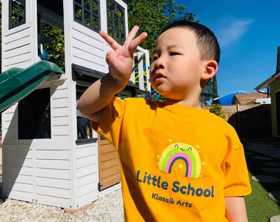 a boy in a yellow shirt