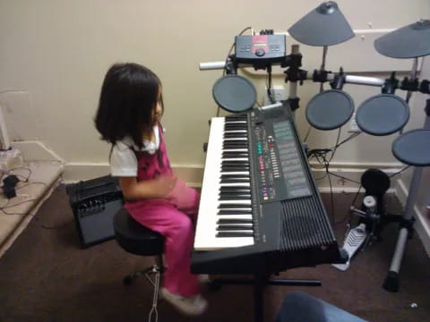 a girl playing a piano