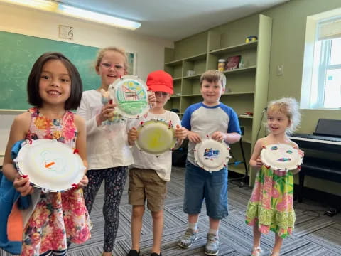 a group of children holding plates