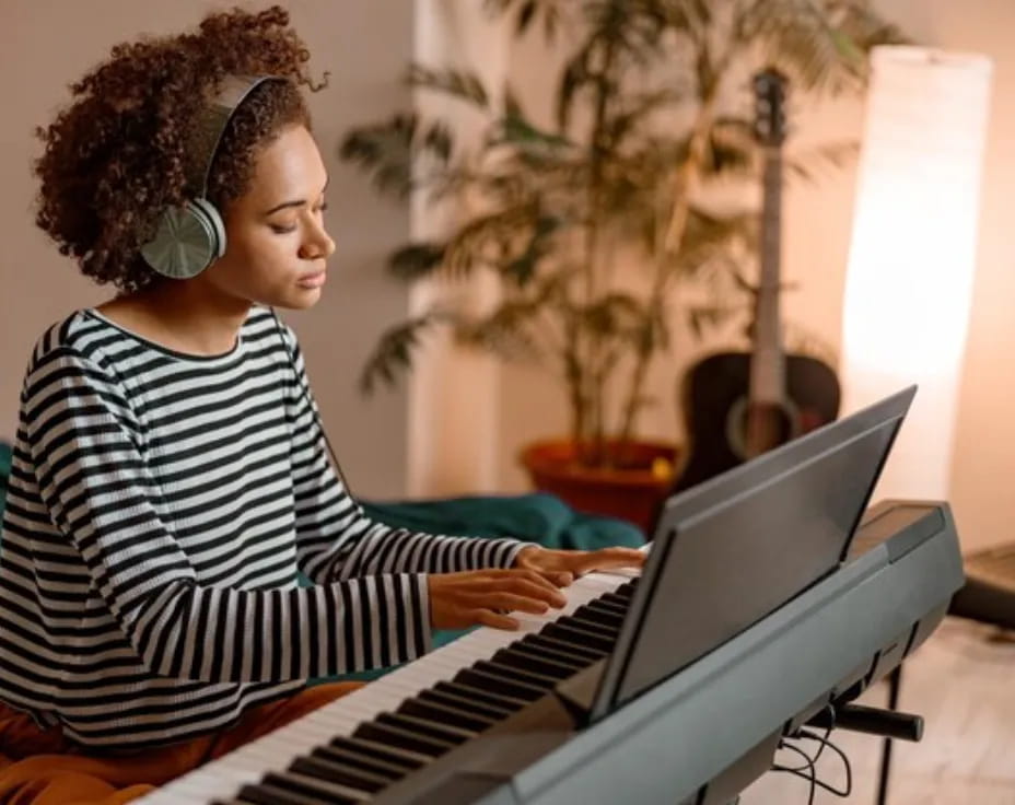 a woman playing a piano
