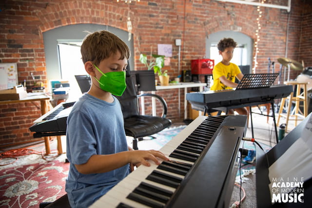 a boy playing a piano