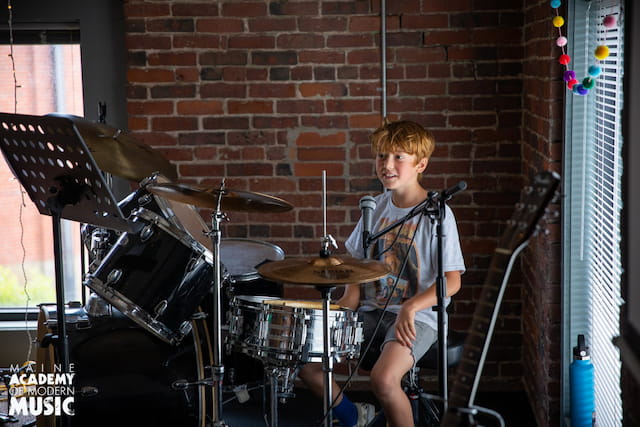 a boy playing drums