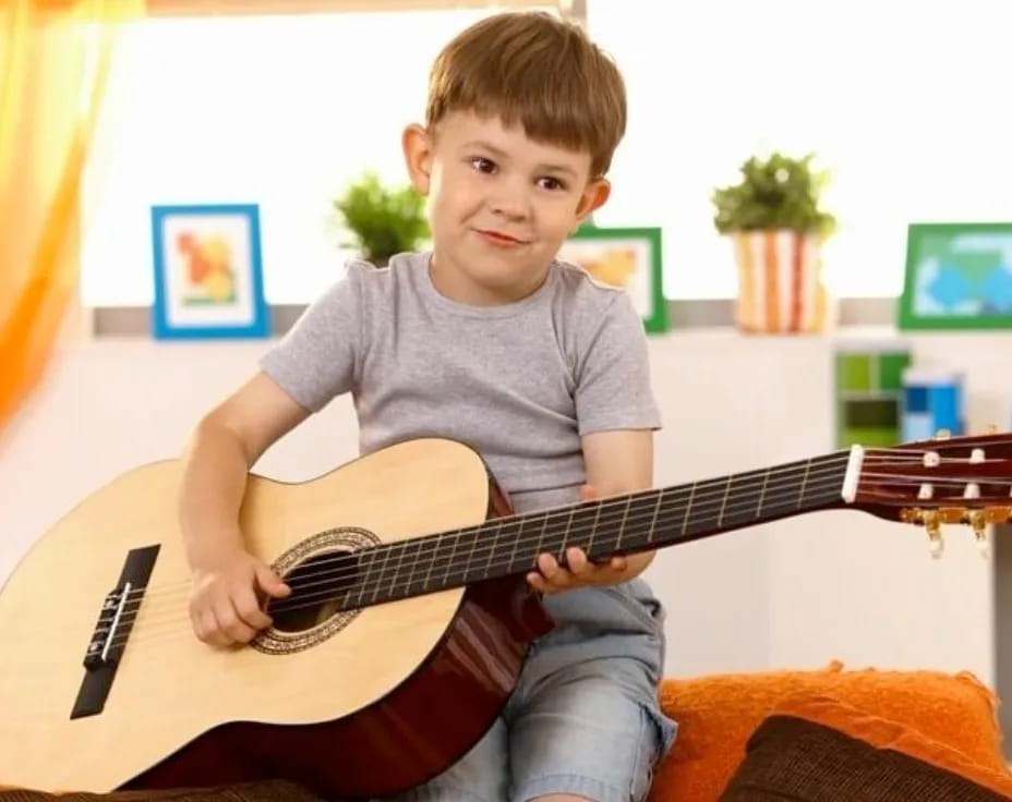 a boy playing a guitar