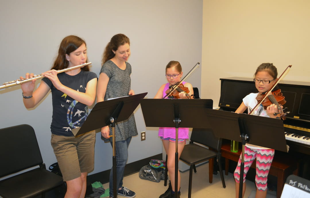 a group of kids playing musical instruments