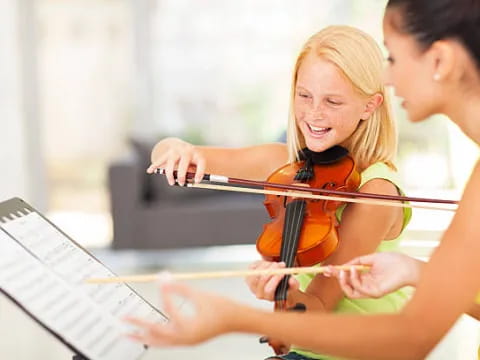 a woman playing a violin
