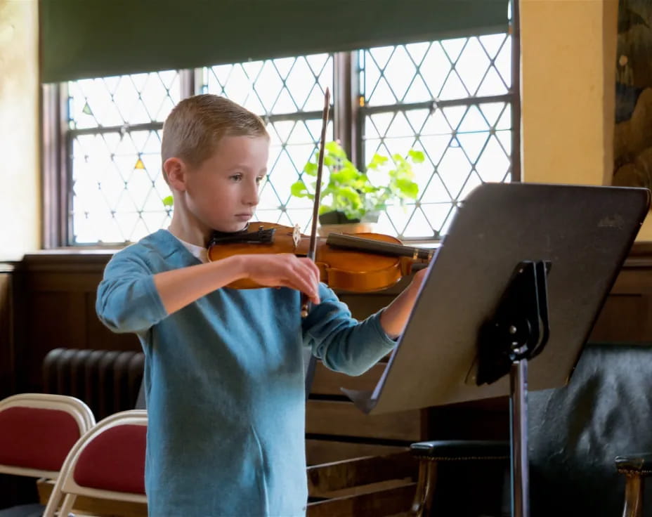 a boy playing a piano
