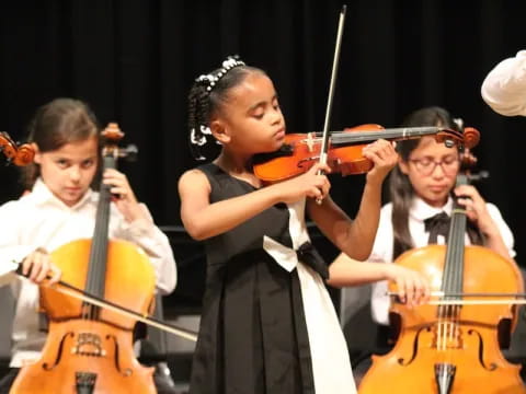 a group of kids playing violin