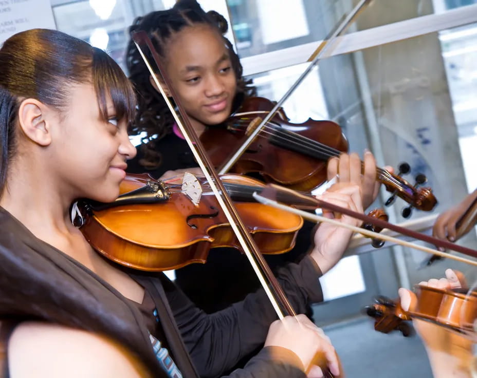 a woman playing a violin