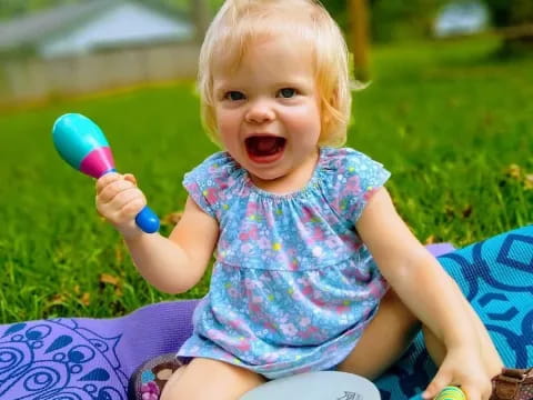 a baby holding a toy