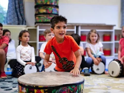 a group of children playing drums