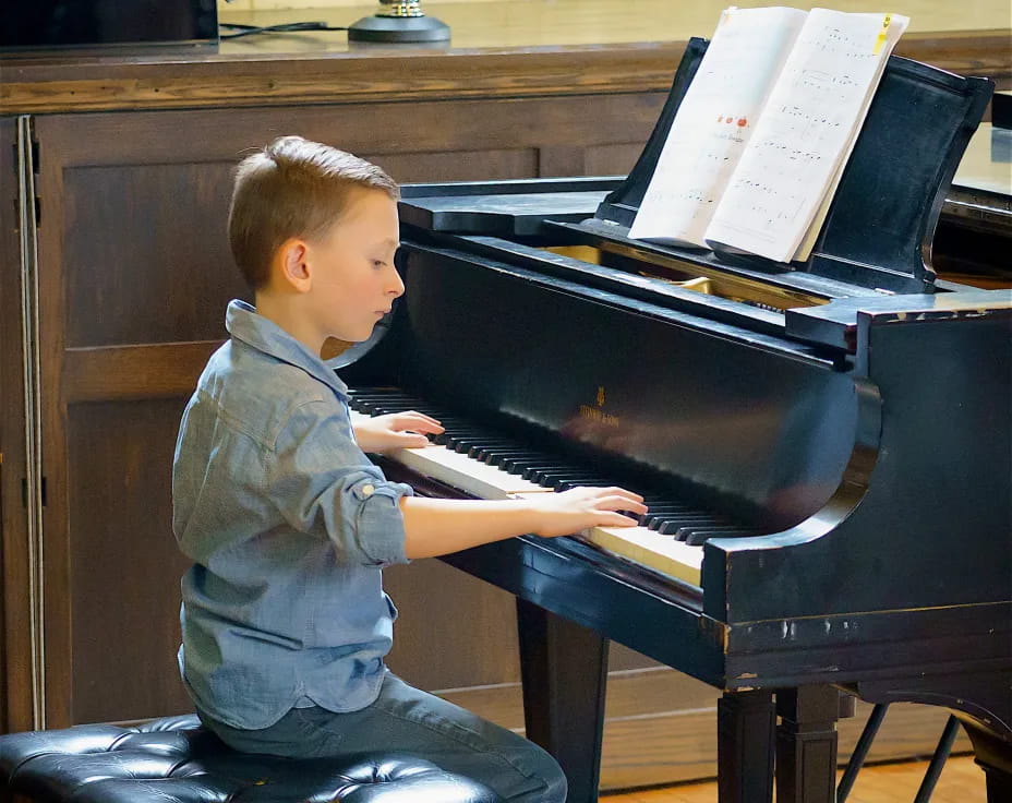 a boy playing a piano