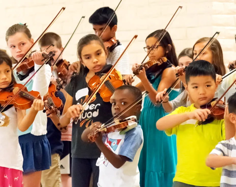 a group of children playing violin