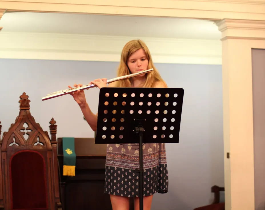 a woman holding a flute