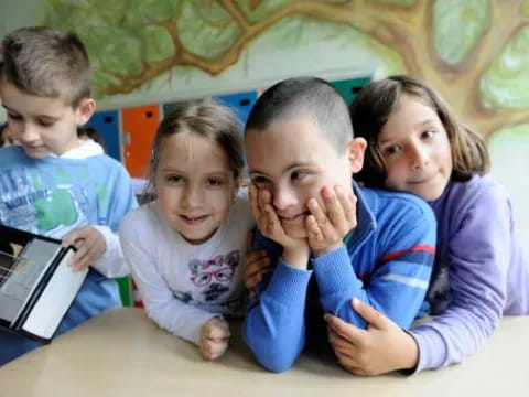 a group of children looking at a book