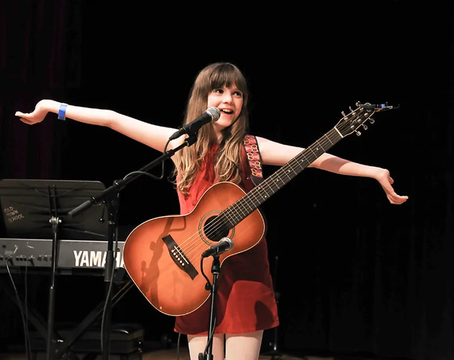 a woman playing a guitar