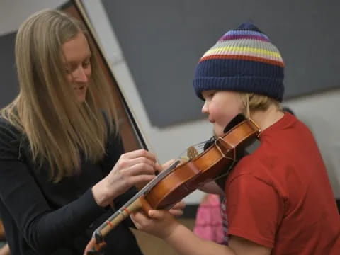 a woman playing a violin