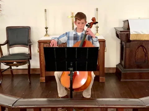 a boy playing a violin