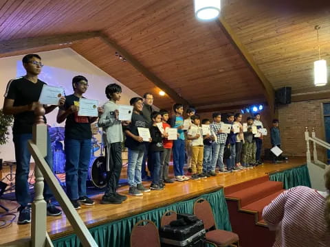 a group of people holding papers