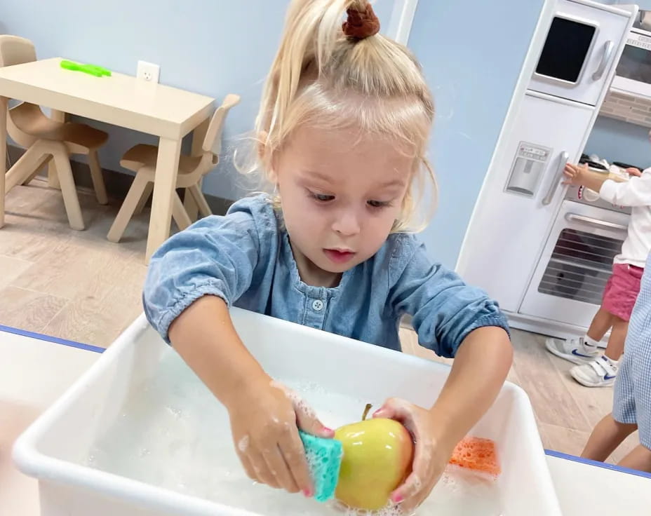 a little girl playing with a toy