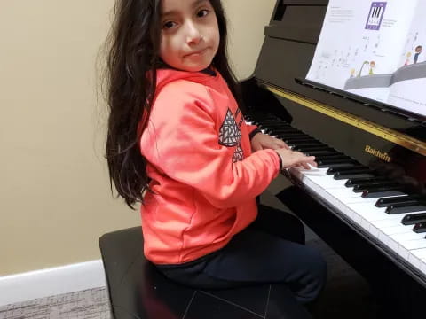 a person sitting at a piano