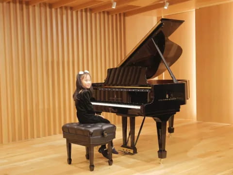 a person sitting at a piano