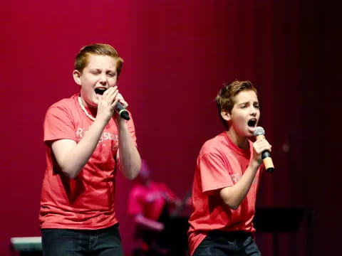 a couple of men singing into microphones