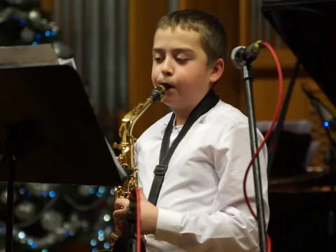 a boy playing a saxophone