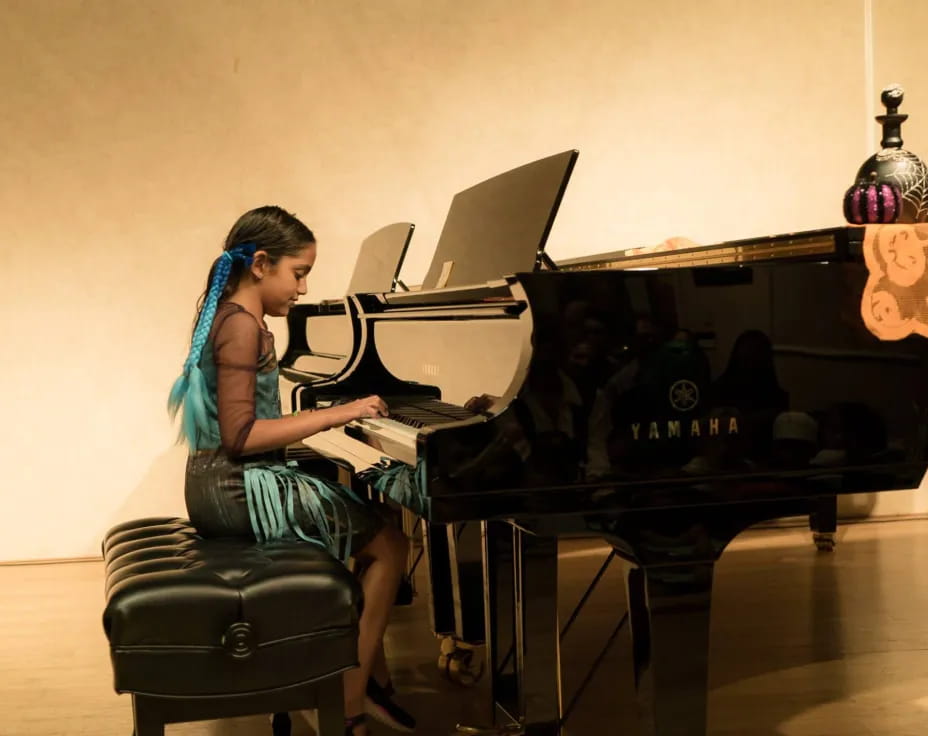 a woman playing the piano