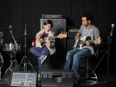 a couple of men playing guitars