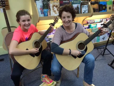 a couple of boys holding guitars