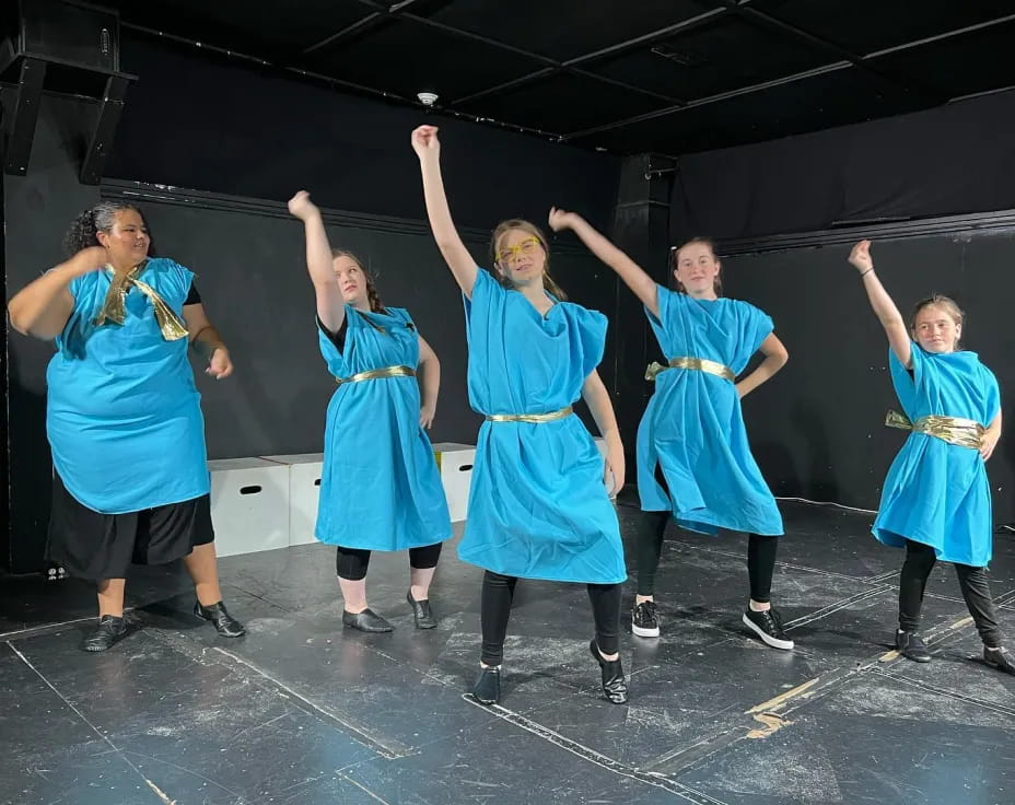 a group of women in blue dresses
